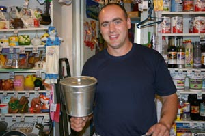 Myyj Aleksei Justus esittelee kaupan runsaasta valikoimasta vesisilit, "pesuniekkaa," joka voidaan kiinnitt vaikkapa talon ulkoseinn puutarhatiden jlkeist ksienpesua varten. Foto: HILKKA JUKARAINEN